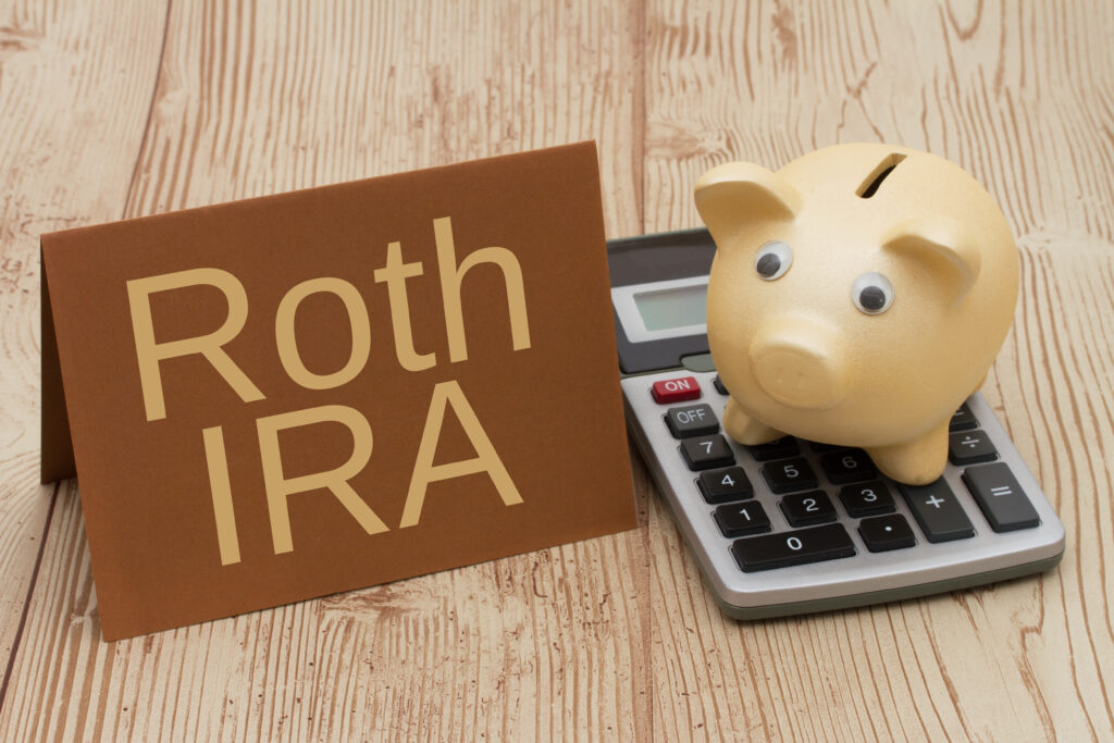 Having a Roth IRA plan, A golden piggy bank, card and calculator